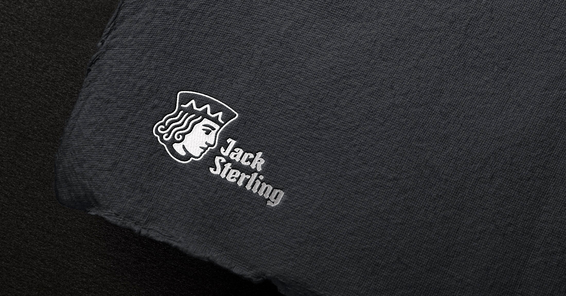 Jack Sterling logo featuring a crowned head profile and wordmark, printed on dark textured paper